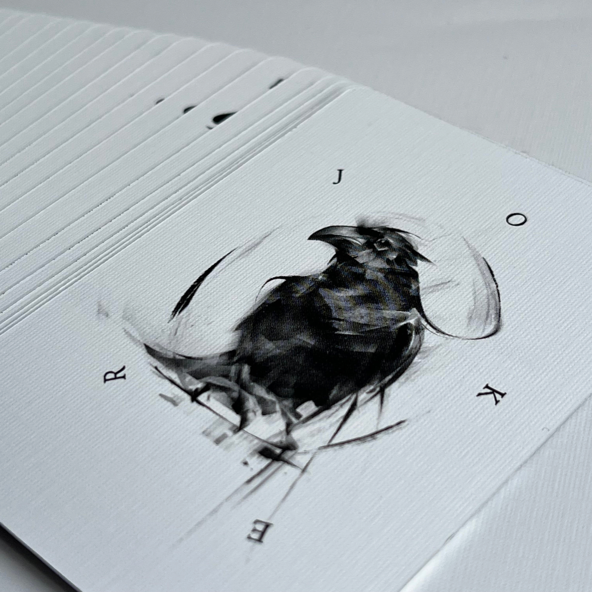 Be Like A Crow playing cards spread across a light surface showing black bird illustrations