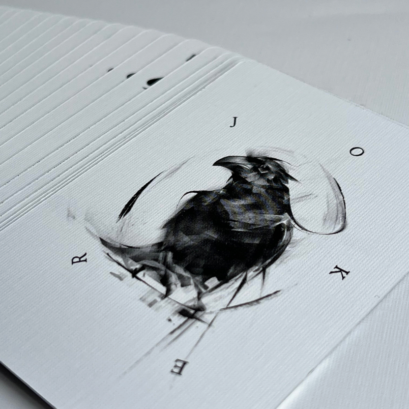 Be Like A Crow playing cards spread across a light surface showing black bird illustrations