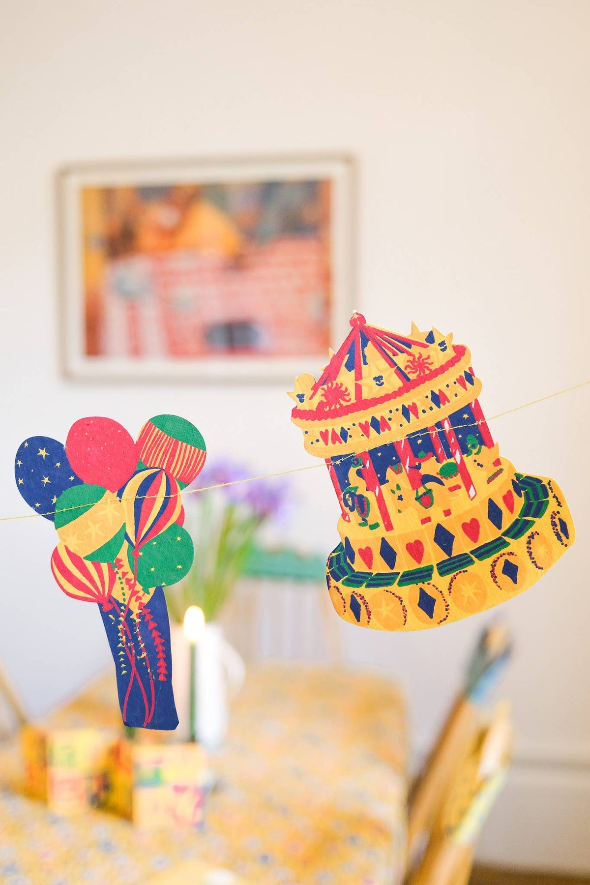 Birthday Party Garland Celebration Decor balloon and carousel detail hanging across a decorated dining room