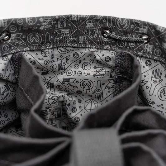 Close-up of interior patterning in Laura Bailey's dice bag of hording bag of holding.  Grey with blackline drawings of critical role icons and symbols of arcana