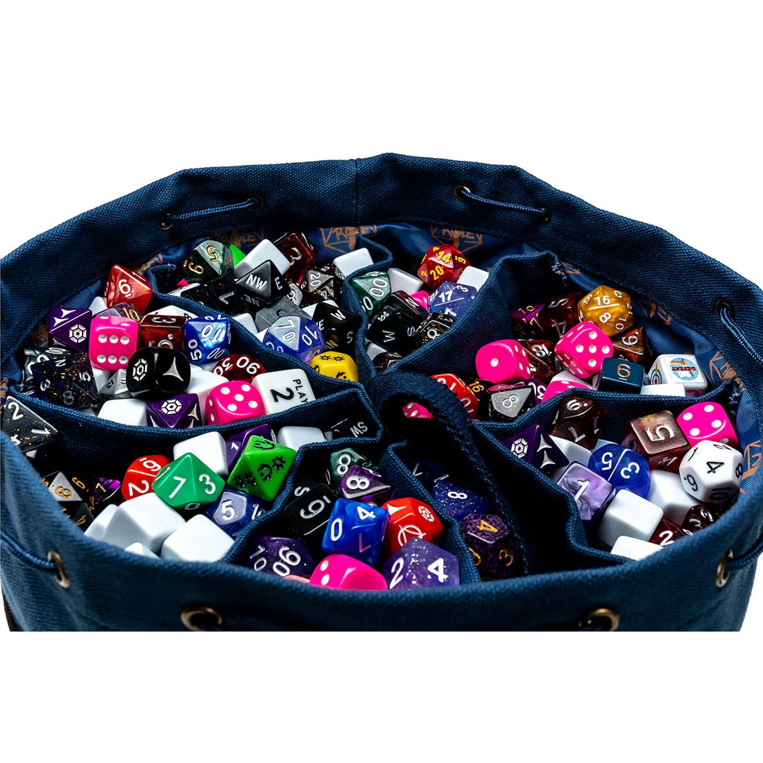 Large collection of colorful dice in separate compartments of the blue and brown dice bag on a white background