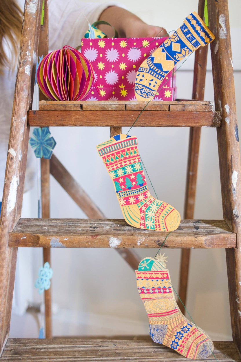 East End Press patterned stocking garland displayed with colorful holiday decorations