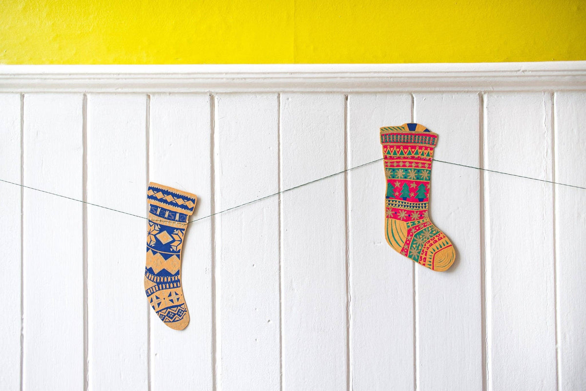 East End Press Festive Stockings Sewn Garland hanging across a white holiday mantel