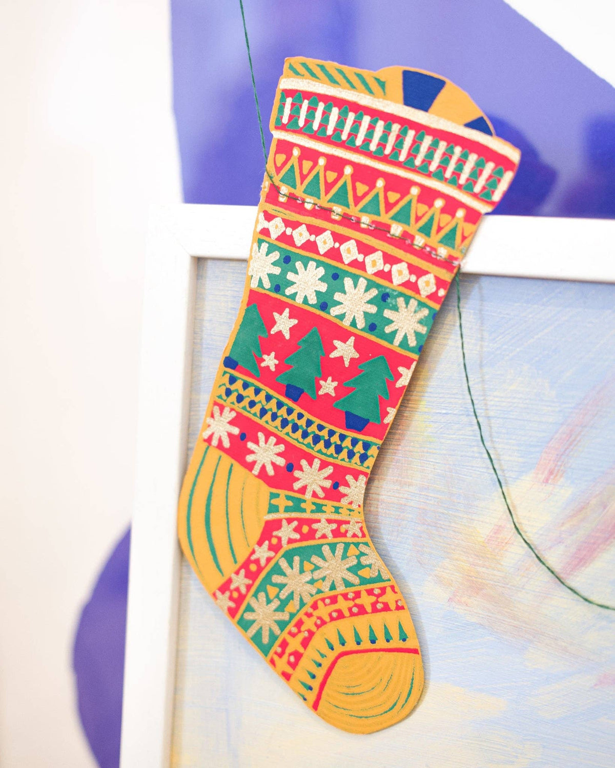 Close-up of a colorful hand screen printed stocking from the East End Press festive garland