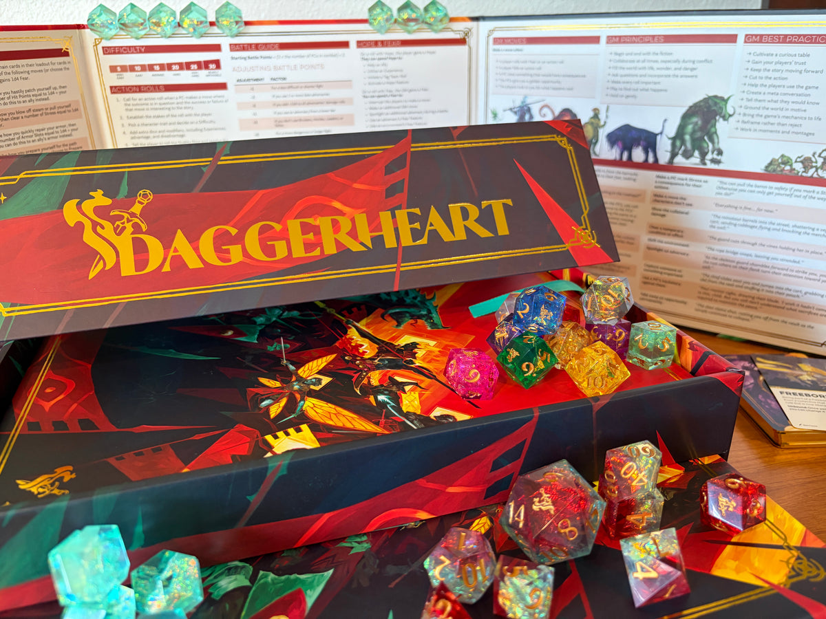 Gold foil Daggerheart logo on the Hope & Fear Deluxe Edition collector's box with deluxe dice displayed.