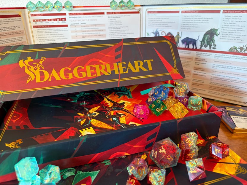 Gold foil Daggerheart logo on the Hope & Fear Deluxe Edition collector's box with deluxe dice displayed.