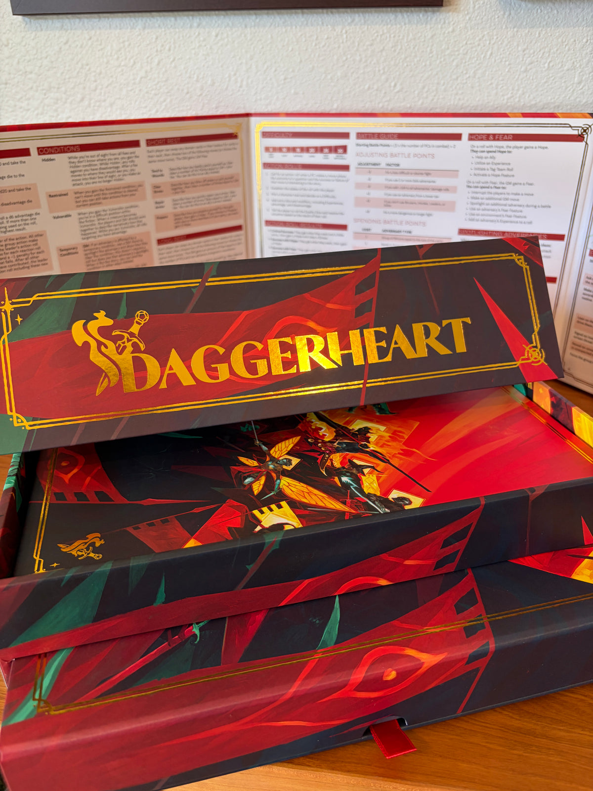 Close-up of the gold foil Daggerheart logo on the Hope & Fear Deluxe Edition collector's box.