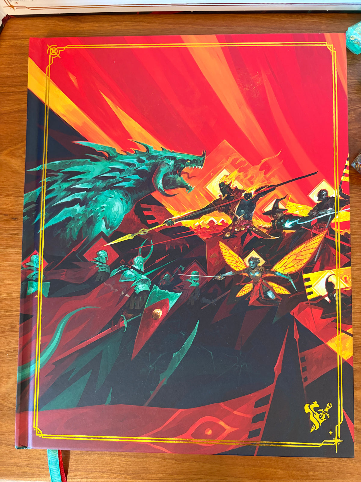 Close-up of the Daggerheart Hope & Fear Deluxe Edition hardcover rulebook featuring vibrant fantasy artwork and gold foil details.
