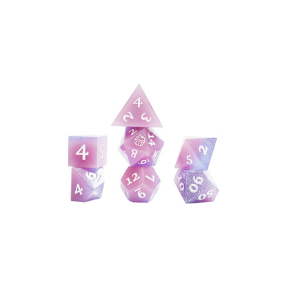 Set of Jester Lavorre purple and pink polyhedral dice stacked on a white background