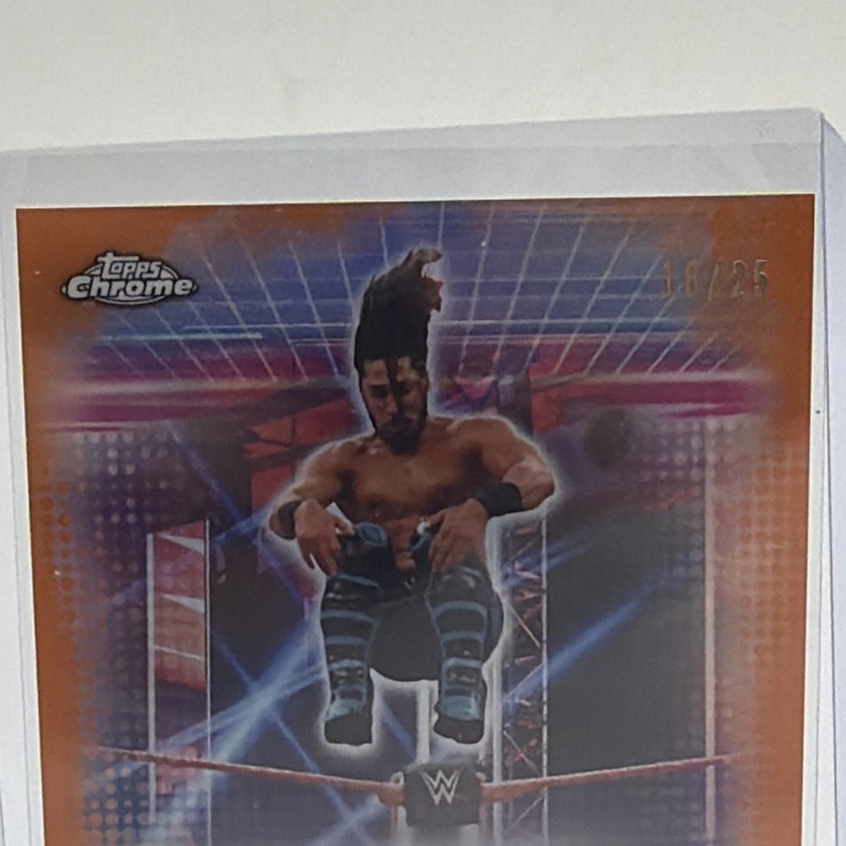 Angled front view of Mustafa Ali Topps Chrome WWE Orange Refractor autograph numbered 18/25