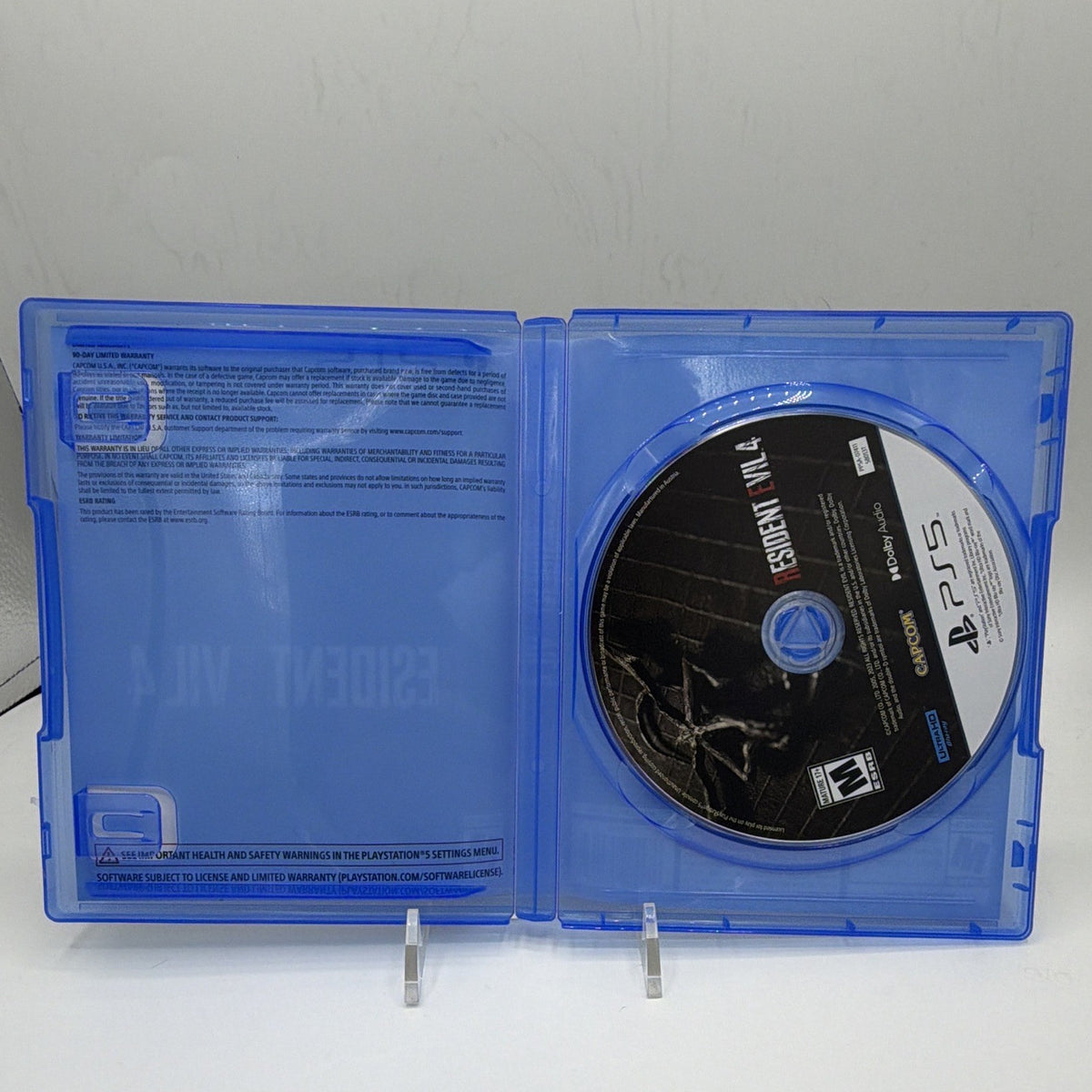 Open Resident Evil 4 PS5 original case showing the game disc