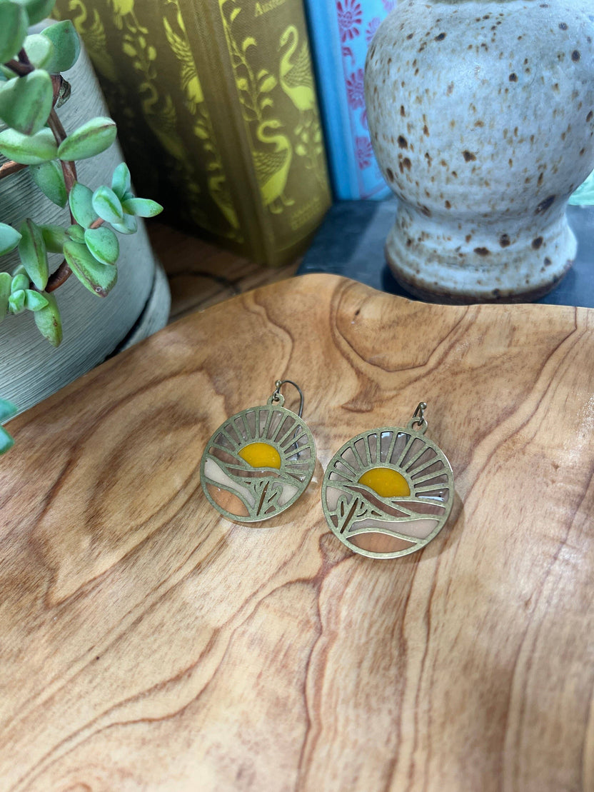 sunset earrings, stained glass resin earrings, brass sunset earrings, colorful statement earrings, nature inspired earrings, sunset landscape jewelry, handmade resin earrings, boho brass earrings, lightweight dangle earrings, artisan earrings for women, unique sunset jewelry, romantic gift for her, Rogue & Rye earrings, outdoor lover gift, handcrafted scenic earrings, resin stained glass jewelry, modern brass earrings, everyday nature earrings, sunset mountain earrings, warm toned earrings