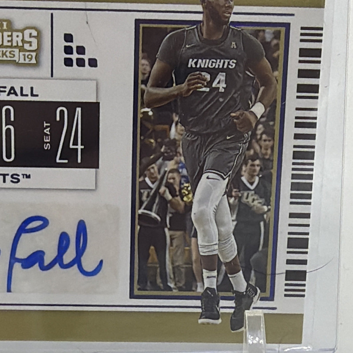 Angled view of Tacko Fall rookie autograph card featuring UCF Knights uniform and College Ticket design