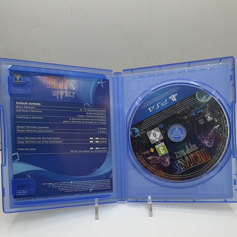 Open Tetris Effect PS4 case showing game disc and included one-page instruction insert