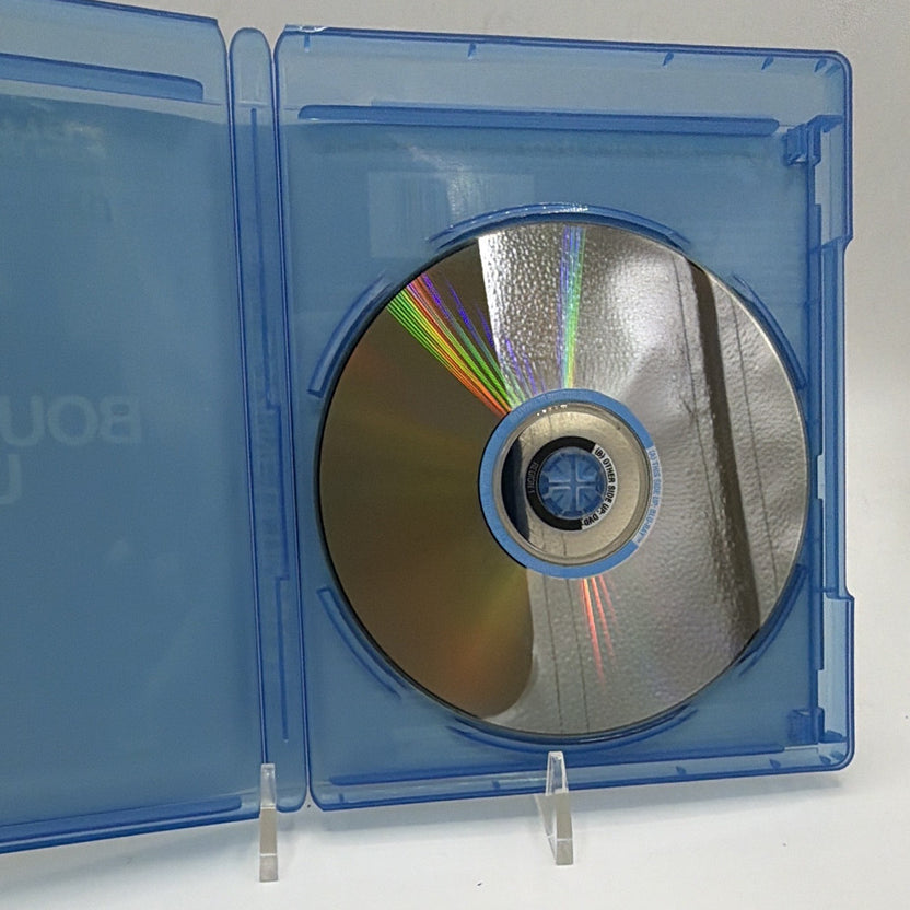 Open The Bourne Ultimatum case showing the included Blu-ray and DVD movie disc