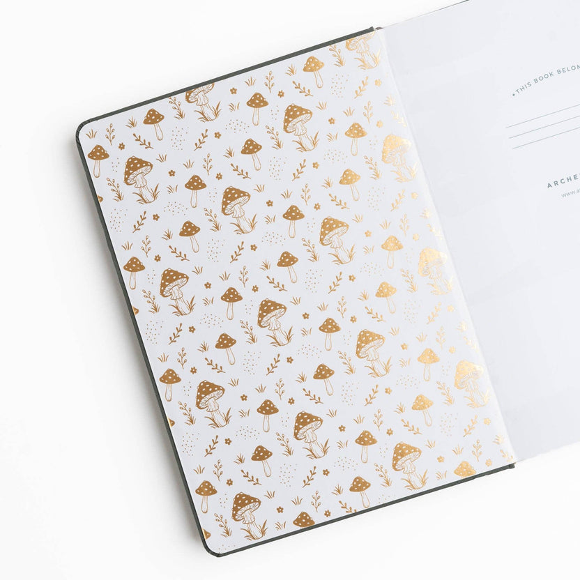 Archer and Olive Mushrooms journal open to illustrated mushroom endpaper and white pages