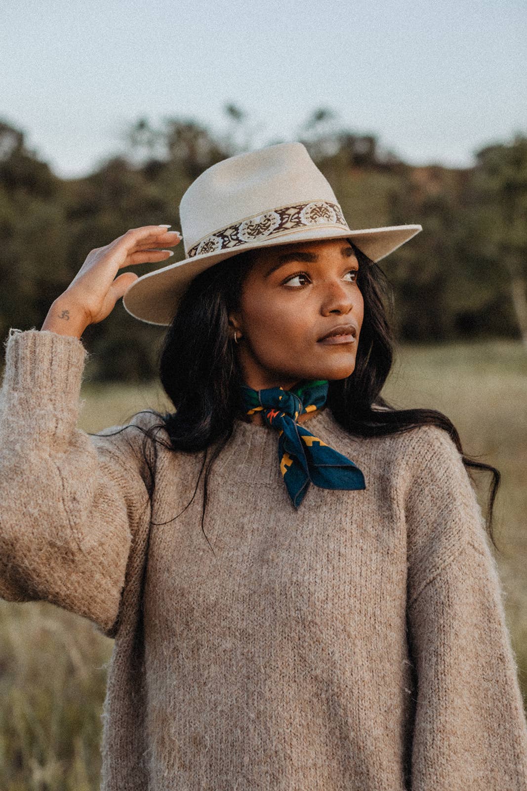 Endless Bloom bandana by Bandits Bandanas featuring four stylized orange foxes arranged in a circular floral pattern on a deep teal background with yellow flowers