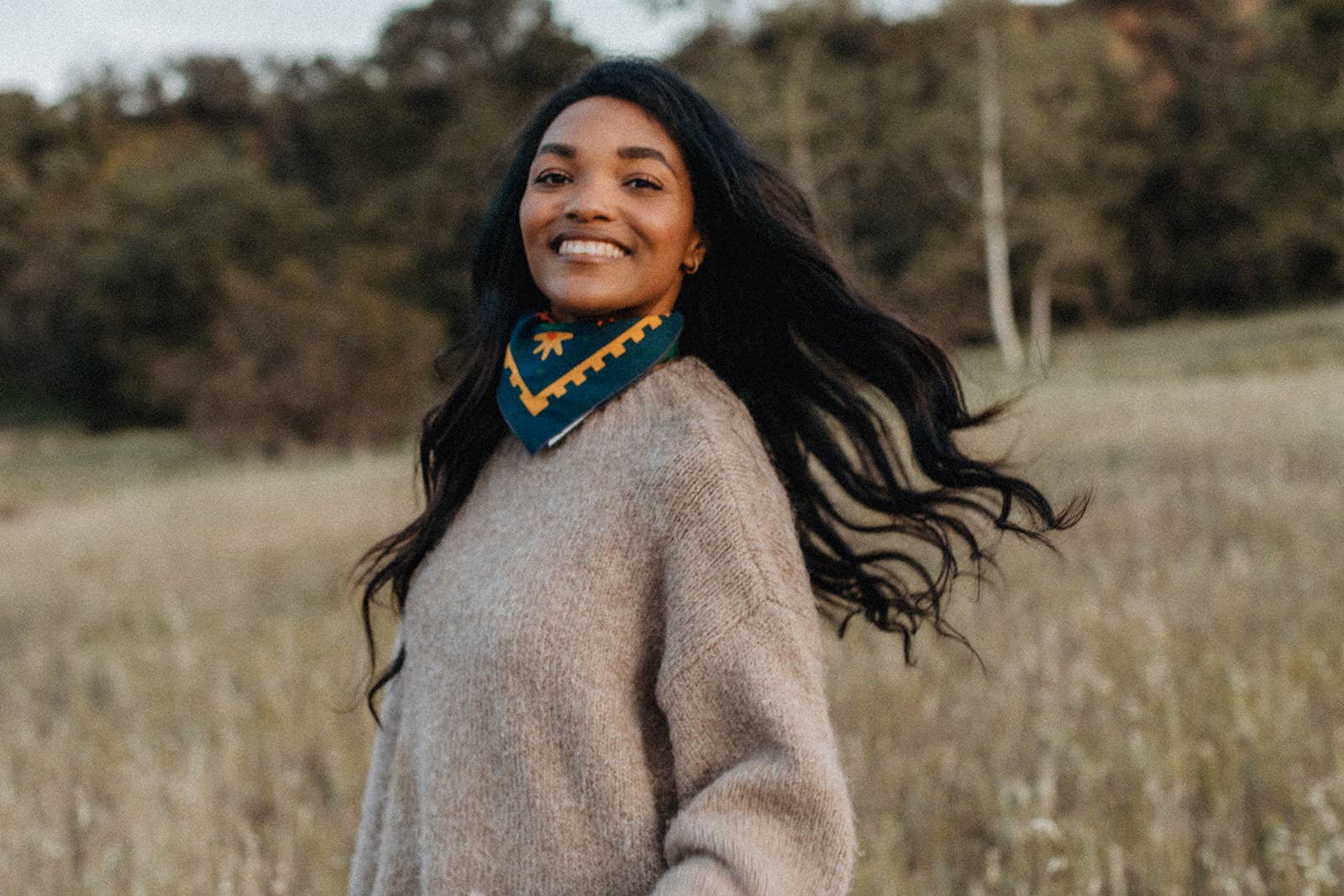Endless Bloom bandana by Bandits Bandanas featuring four stylized orange foxes arranged in a circular floral pattern on a deep teal background with yellow flowers