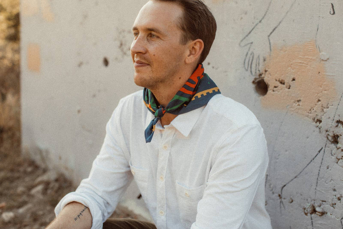 Endless Bloom bandana by Bandits Bandanas featuring four stylized orange foxes arranged in a circular floral pattern on a deep teal background with yellow flowers