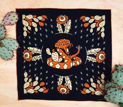 Bandits Cactus Dream bandana by Brothers Design Co. featuring a coiled rattlesnake surrounded by prickly pear cactus, cactus flowers, and Southwestern-inspired artwork.