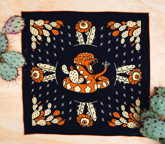 Bandits Cactus Dream bandana by Brothers Design Co. featuring a coiled rattlesnake surrounded by prickly pear cactus, cactus flowers, and Southwestern-inspired artwork.