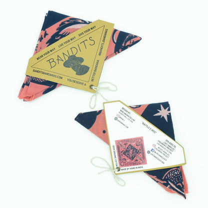Bandits Rattle & Hiss bandana by Nuri Amanatullah folded with the Bandits hang tag, front and back packaging cards displayed.