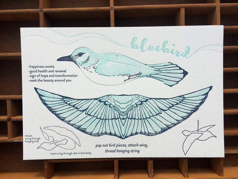 bluebird pop-out card, letterpress bluebird greeting card, bluebird symbolism happiness, renewal bird card, cotton paper pop-out card, light and dark blue letterpress, 3d bird ornament card, displayable bird paper craft, woodland bird greeting card, birthday bluebird card, artisan letterpress stationery, hanging bird ornament card, blackbird letterpress pop-out collection, rogue & rye nature cards, symbolic bird greeting card