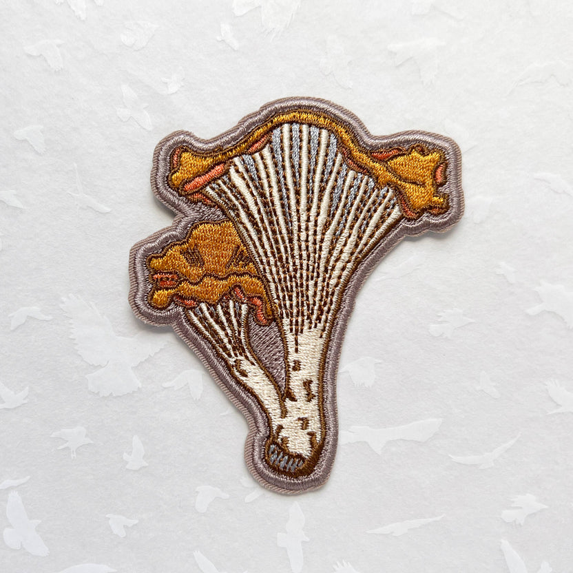 chanterelle mushroom patch, embroidered mushroom patch, golden mushroom iron-on, fungi sew-on patch, woodland embroidery patch, textured chanterelle applique, backpack mushroom patch, jean jacket patch, forager gift, artisan embroidered patch, blackbird letterpress patch, cottagecore mushroom accessory, nature lover patch, rogue & rye mushroom patch, embroidered chanterelle design