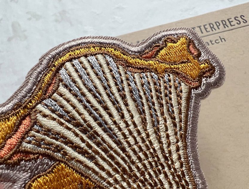 chanterelle mushroom patch, embroidered mushroom patch, golden mushroom iron-on, fungi sew-on patch, woodland embroidery patch, textured chanterelle applique, backpack mushroom patch, jean jacket patch, forager gift, artisan embroidered patch, blackbird letterpress patch, cottagecore mushroom accessory, nature lover patch, rogue & rye mushroom patch, embroidered chanterelle design