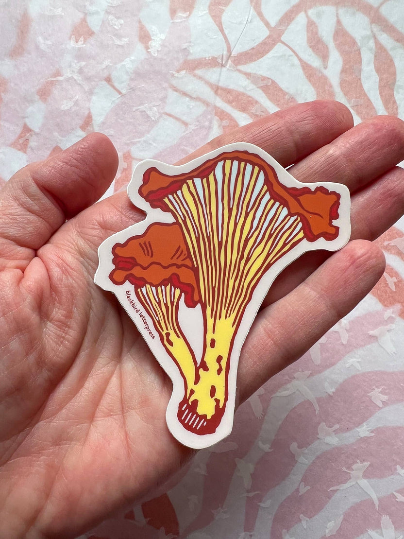 chanterelle mushroom sticker, mushroom vinyl sticker, fungi vinyl decal, linocut mushroom illustration, Élise Lassonde art, Blackbird Letterpress sticker, matte vinyl die-cut sticker, waterproof mushroom sticker, weatherproof uv-protected sticker, forager gift, forest mushroom art, botanical sticker, durable laptop decal, water bottle sticker, artisan paper goods, small-batch maker sticker, Rogue & Rye sticker collection, wild mushroom illustration, made in USA vinyl sticker