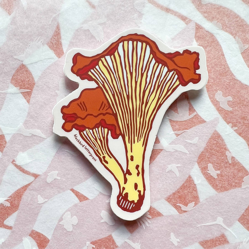 chanterelle mushroom sticker, mushroom vinyl sticker, fungi vinyl decal, linocut mushroom illustration, Élise Lassonde art, Blackbird Letterpress sticker, matte vinyl die-cut sticker, waterproof mushroom sticker, weatherproof uv-protected sticker, forager gift, forest mushroom art, botanical sticker, durable laptop decal, water bottle sticker, artisan paper goods, small-batch maker sticker, Rogue & Rye sticker collection, wild mushroom illustration, made in USA vinyl sticker