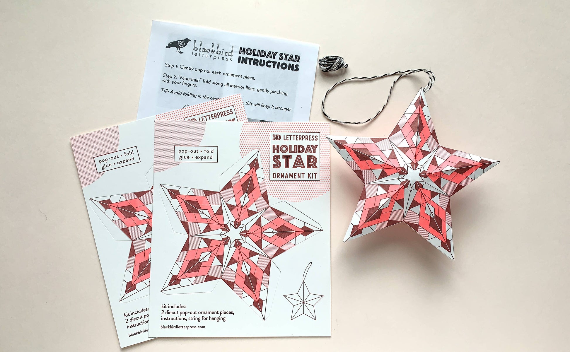 geometric holiday star kit, diy star ornament, neon red letterpress ornament, holiday paper craft kit, christmas diy craft, blackbird letterpress ornament kit, recycled white paper craft, pop-out star ornament, modern holiday décor, fold and glue ornament, handmade holiday craft kit, seasonal crafting project, vibrant holiday ornament, rogue & rye craft collection, 3d paper star ornament