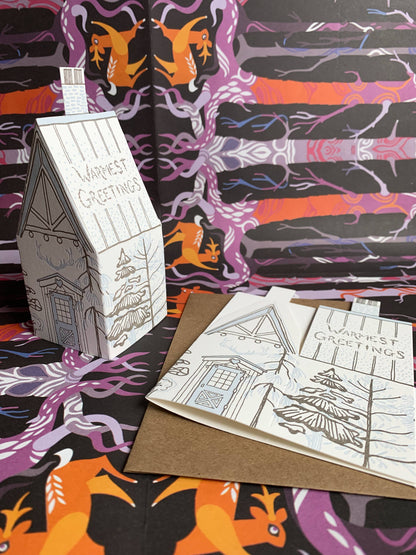 warmest greetings card, holiday cabin card, 3d house holiday card, winter cabin letterpress card, ice blue letterpress, forest brown letterpress, foldable holiday house card, buildable cabin card, die-cut Christmas card, miniature cabin card, artisan holiday stationery, Blackbird Letterpress holiday collection, Rogue & Rye holiday cards, winter greeting card, displayable paper craft card, Élise Lassonde illustration, A2 letterpress Christmas card