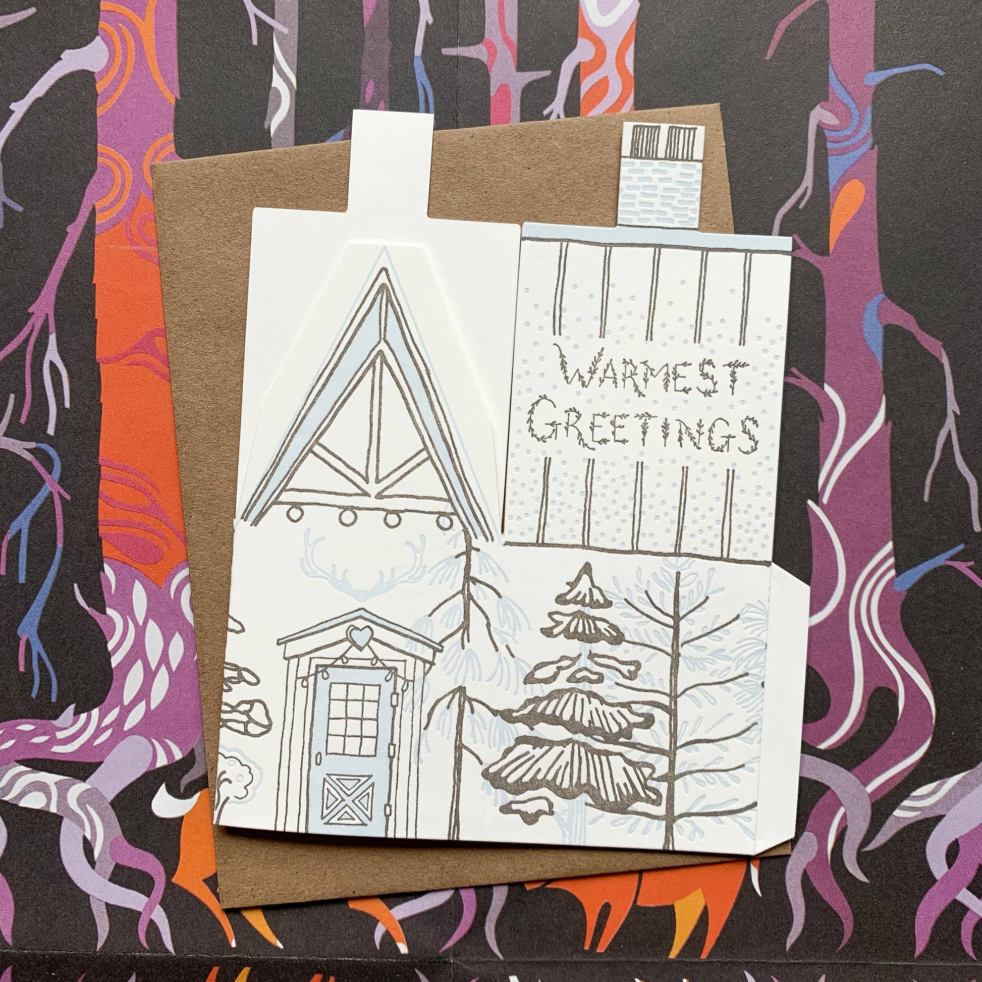 warmest greetings card, holiday cabin card, 3d house holiday card, winter cabin letterpress card, ice blue letterpress, forest brown letterpress, foldable holiday house card, buildable cabin card, die-cut Christmas card, miniature cabin card, artisan holiday stationery, Blackbird Letterpress holiday collection, Rogue & Rye holiday cards, winter greeting card, displayable paper craft card, Élise Lassonde illustration, A2 letterpress Christmas card