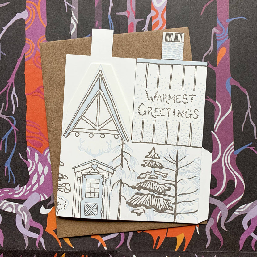 warmest greetings card, holiday cabin card, 3d house holiday card, winter cabin letterpress card, ice blue letterpress, forest brown letterpress, foldable holiday house card, buildable cabin card, die-cut Christmas card, miniature cabin card, artisan holiday stationery, Blackbird Letterpress holiday collection, Rogue & Rye holiday cards, winter greeting card, displayable paper craft card, Élise Lassonde illustration, A2 letterpress Christmas card