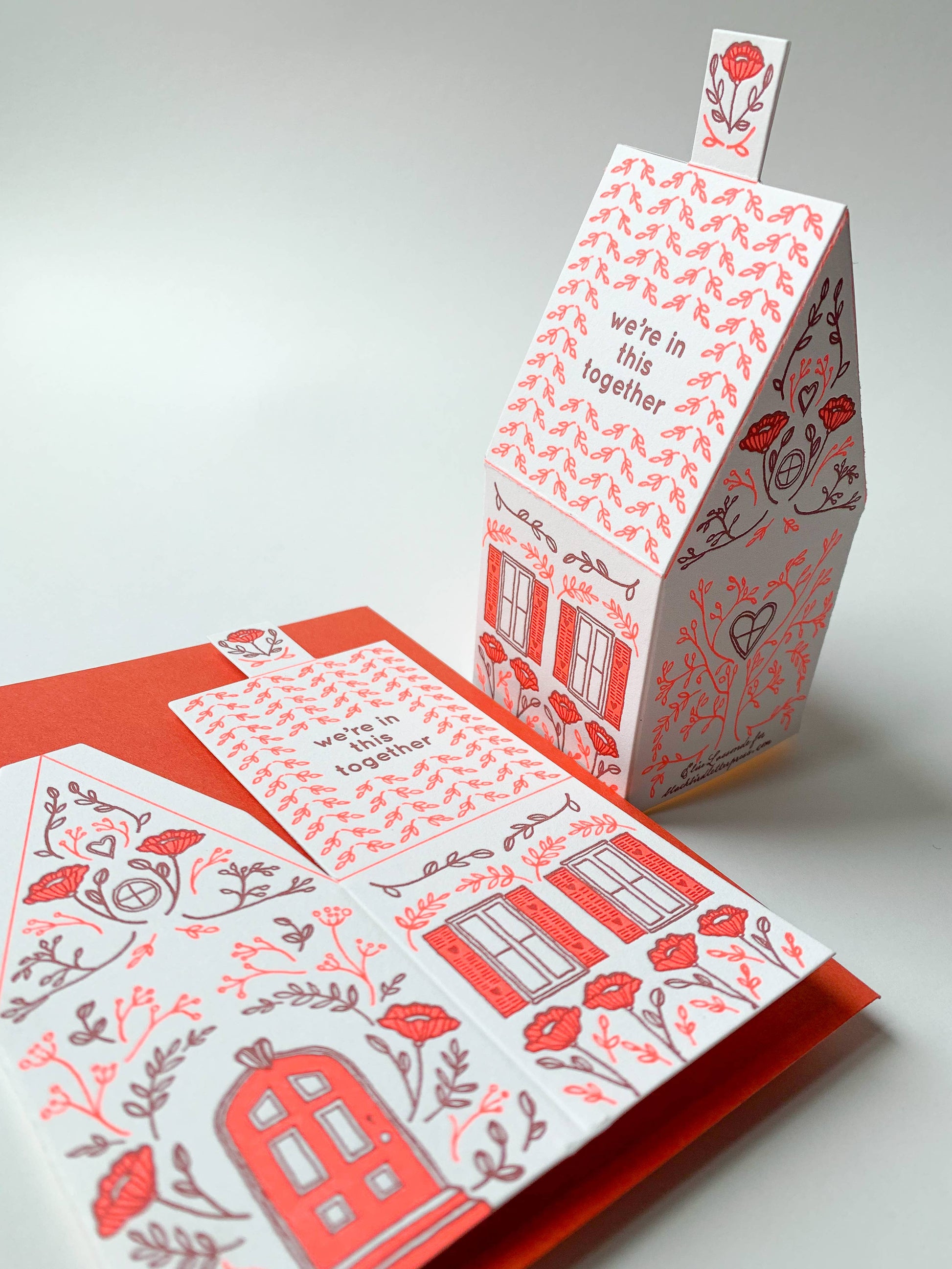 we’re in this together card, 3D house card, letterpress house card, neon red letterpress, foldable house card, buildable paper house, die-cut letterpress card, supportive greeting card, encouragement card, friendship card, solidarity gift, cotton paper card, miniature house card, displayable card, artisan letterpress stationery, Blackbird Letterpress card, Rogue & Rye letterpress collection, A2 letterpress greeting card, paper craft house card, illustrated by Élise Lassonde