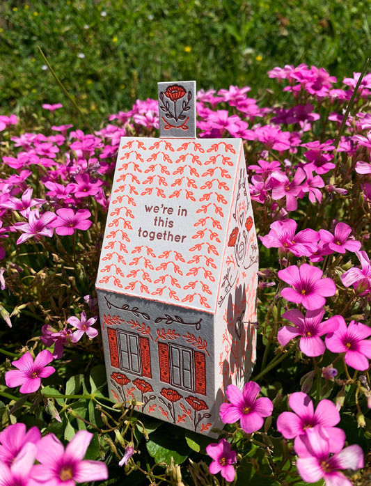 we’re in this together card, 3D house card, letterpress house card, neon red letterpress, foldable house card, buildable paper house, die-cut letterpress card, supportive greeting card, encouragement card, friendship card, solidarity gift, cotton paper card, miniature house card, displayable card, artisan letterpress stationery, Blackbird Letterpress card, Rogue & Rye letterpress collection, A2 letterpress greeting card, paper craft house card, illustrated by Élise Lassonde