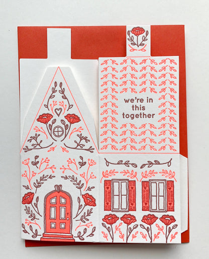 we’re in this together card, 3D house card, letterpress house card, neon red letterpress, foldable house card, buildable paper house, die-cut letterpress card, supportive greeting card, encouragement card, friendship card, solidarity gift, cotton paper card, miniature house card, displayable card, artisan letterpress stationery, Blackbird Letterpress card, Rogue & Rye letterpress collection, A2 letterpress greeting card, paper craft house card, illustrated by Élise Lassonde