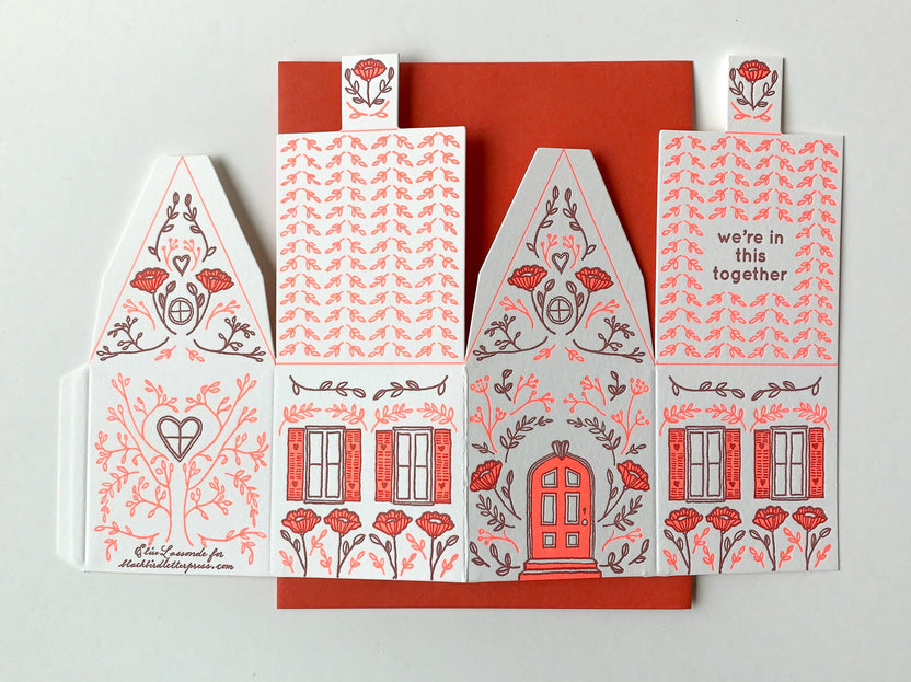 we’re in this together card, 3D house card, letterpress house card, neon red letterpress, foldable house card, buildable paper house, die-cut letterpress card, supportive greeting card, encouragement card, friendship card, solidarity gift, cotton paper card, miniature house card, displayable card, artisan letterpress stationery, Blackbird Letterpress card, Rogue & Rye letterpress collection, A2 letterpress greeting card, paper craft house card, illustrated by Élise Lassonde