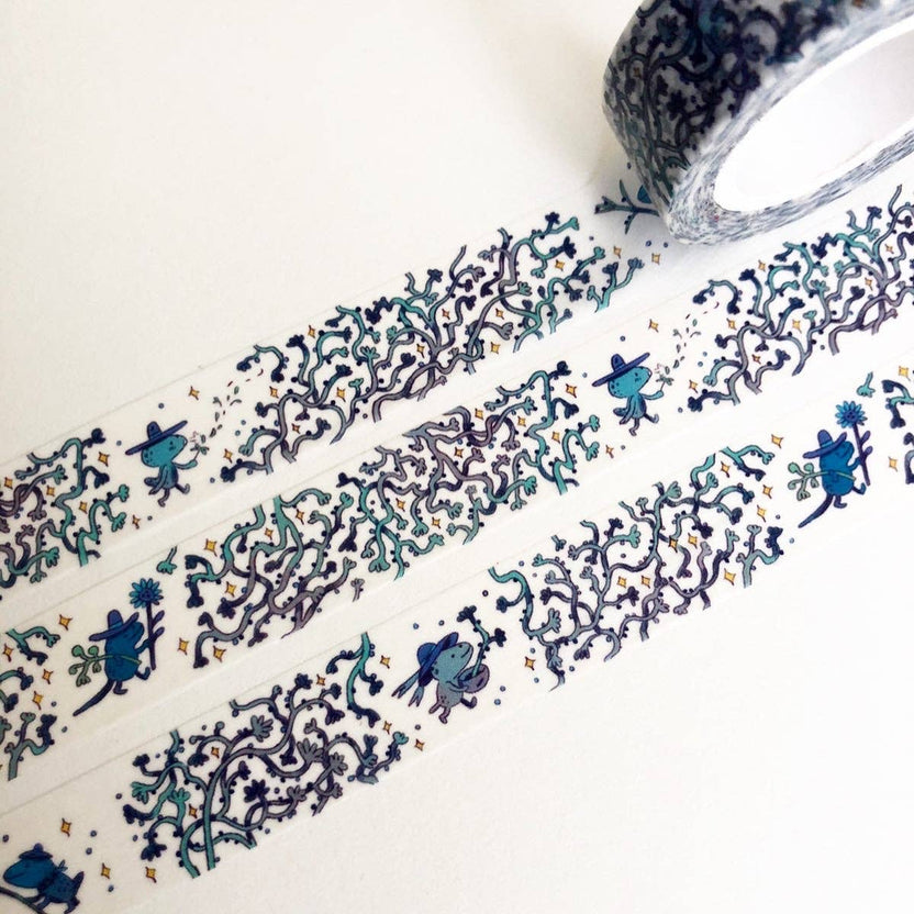 Close view of tiny blue gardeners working among illustrated vines on washi tape