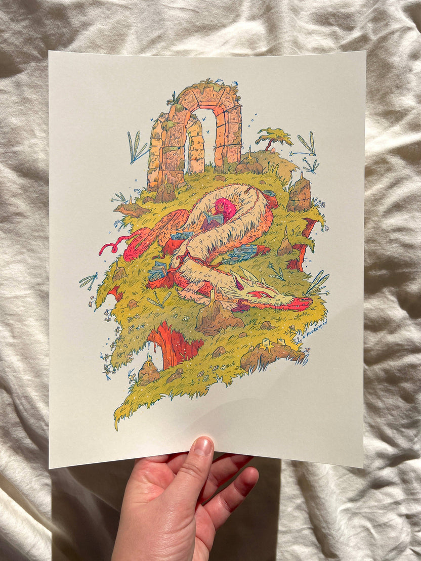 Book Dragon risograph print, Natalie Andrewson riso print, Thought Bubble Comic Festival art, reading dragon illustration, blue yellow fluorescent pink riso, fantasy creature artwork, book lover art print, whimsical dragon illustration, indie printmaker risograph, literary fantasy art, collectible riso print, Rogue & Rye artist collection.
