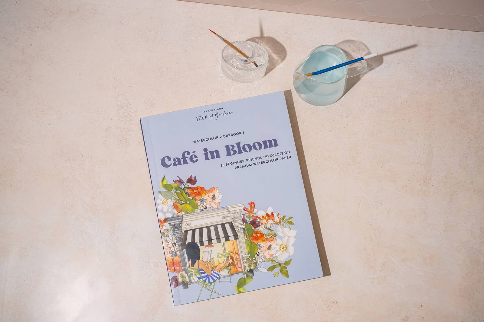 café watercolor workbook, garden watercolor book, beginner watercolor projects, Sarah Simon watercolor book, watercolor painting for adults, paint-in watercolor journal, floral watercolor scenes, cozy art projects, watercolor café illustrations, botanical watercolor practice