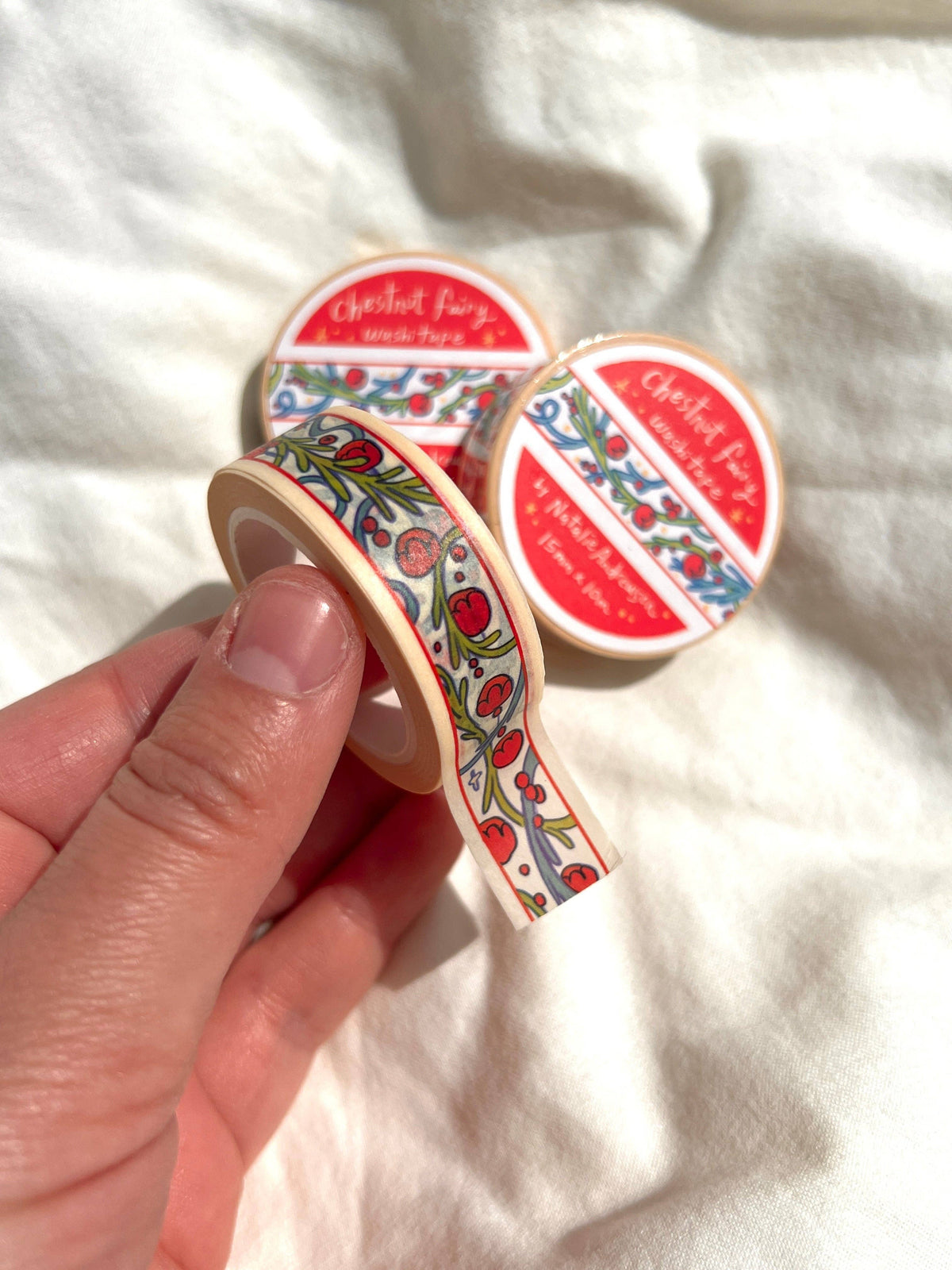 Chestnut Fairy washi tape held in hand showing the repeating illustrated design
