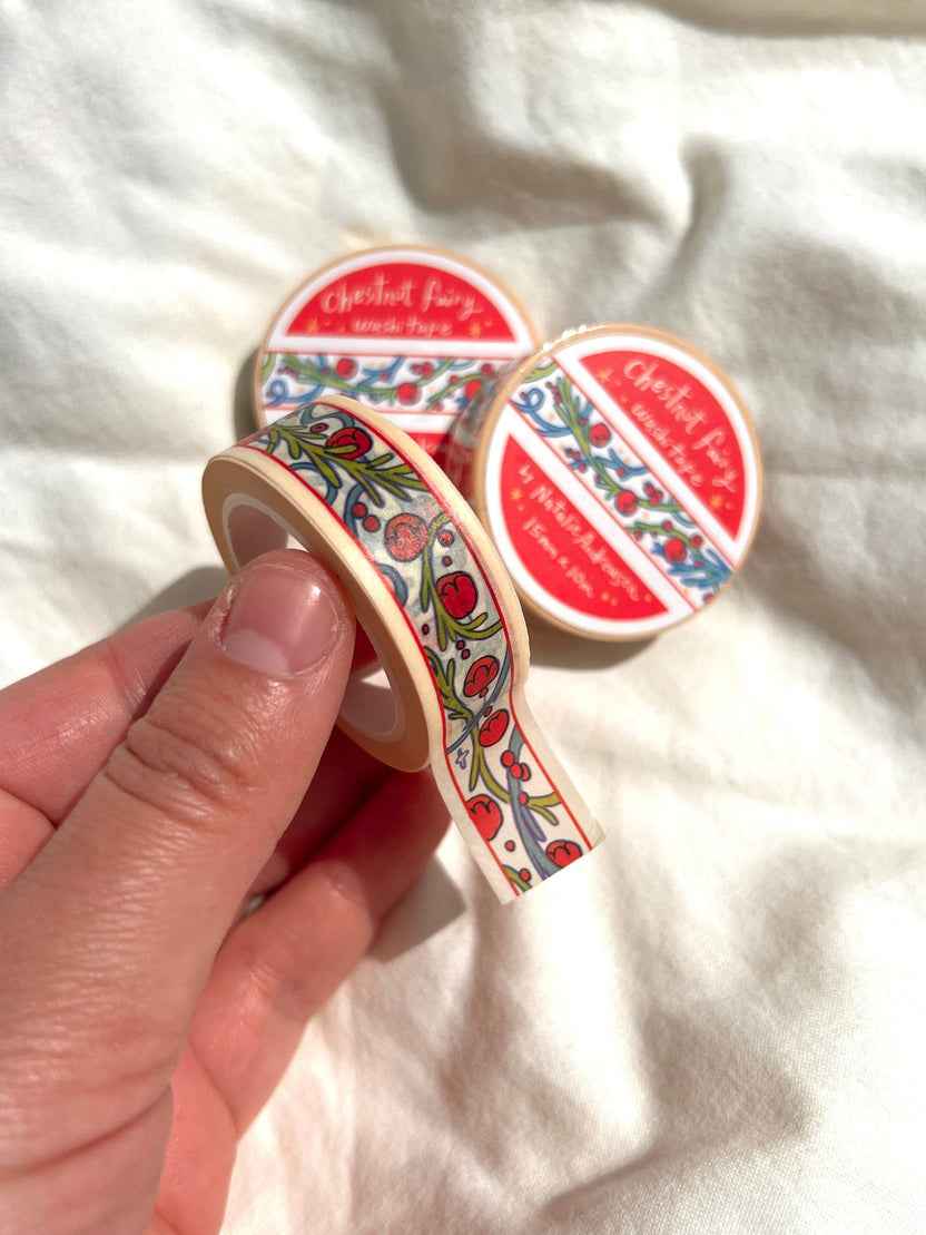 Chestnut Fairy washi tape held in hand showing the repeating illustrated design