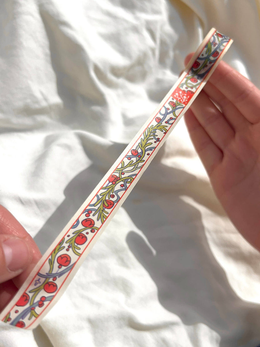 Close-up of Chestnut Fairy washi tape with red, green, and blue storybook illustrations