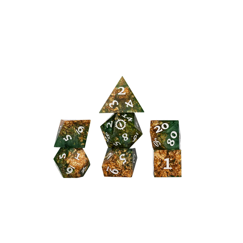 Aramán Seekers polyhedral dice grouped together, showing rich green resin and shimmering gold flakes
