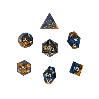 Seven blue and gold polyhedral dice from the Critical Role Aramán Soldiers dice set