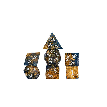 Aramán Soldiers polyhedral dice grouped together, showing deep blue resin and shimmering gold flakes