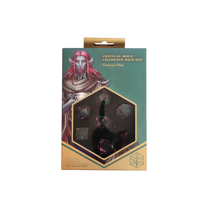 Front of the Critical Role Champion Dice Set: Caduceus Clay collector box featuring character artwork and a hexagonal display window showing the sharp-edged polyhedral dice inside. The packaging is accented with teal and gold tones and includes artwork of Caduceus Clay alongside the pink, purple, and green resin dice inspired by the Blooming Grove.