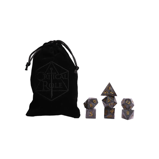 Set of black polyhedral dice with gold numbers and a matching drawstring bag on a white background.